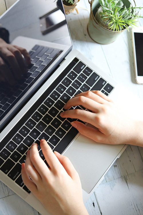 hands typing on laptop computer keyboard, sign up VividSocial